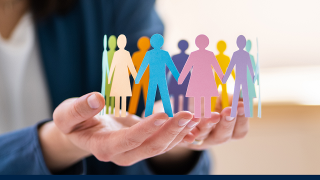 A pair of hands are open, sitting in the palms are a circle of paper cut-outs in human-shapes and in various colours.