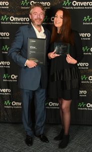 Fergus from National Grid posing in front of the step and repeat banner with Natalie Desty from STEM Returners.