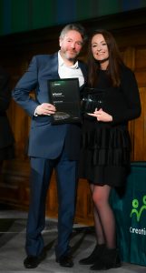 Fergus from National Grid posing in front of the step and repeat banner with Natalie Desty from STEM Returners.