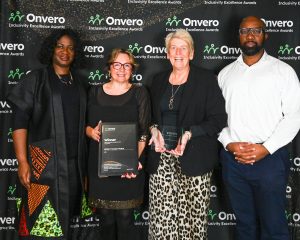 Posing in front of the step and repeat banner.